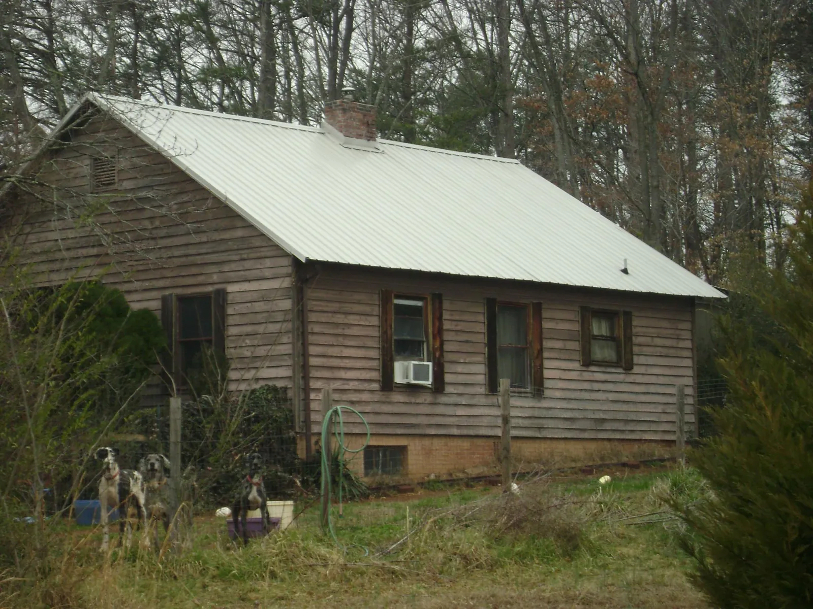 White metal roof on an old wood sided farmhouse, from a Metal Roof Installation job in Vandalia